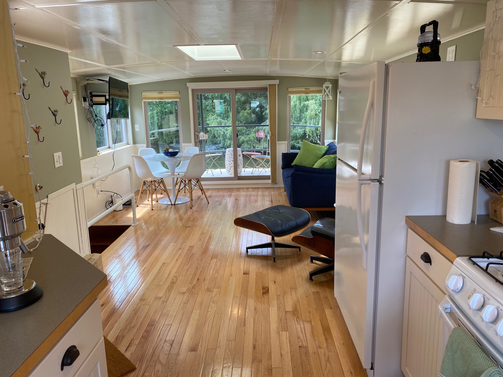Open living space with hardwood floors and Eames chair
